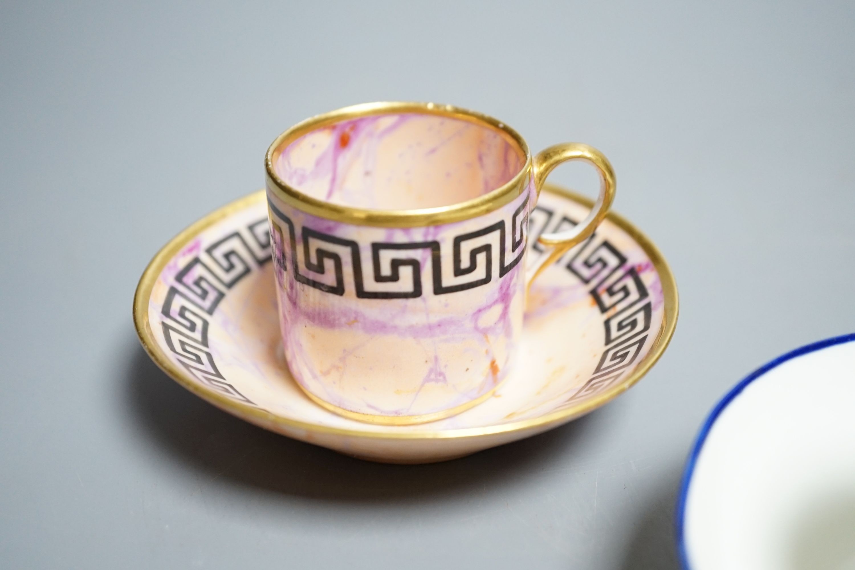 A Derby miniature coffee can and saucer, c.1800-10 and a Pinxton miniature teacup and saucer, c.1800. Provenance - Mona Sattin collection of miniature cups and saucers, collection no.s 112 & 114.